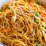 One-Pot Teriyaki Noodles: A Quick and Easy Family Meal 2 Glossy teriyaki noodles in a large pot with colorful vegetables, garnished with sesame seeds and green onions, showing the rich sauce coating